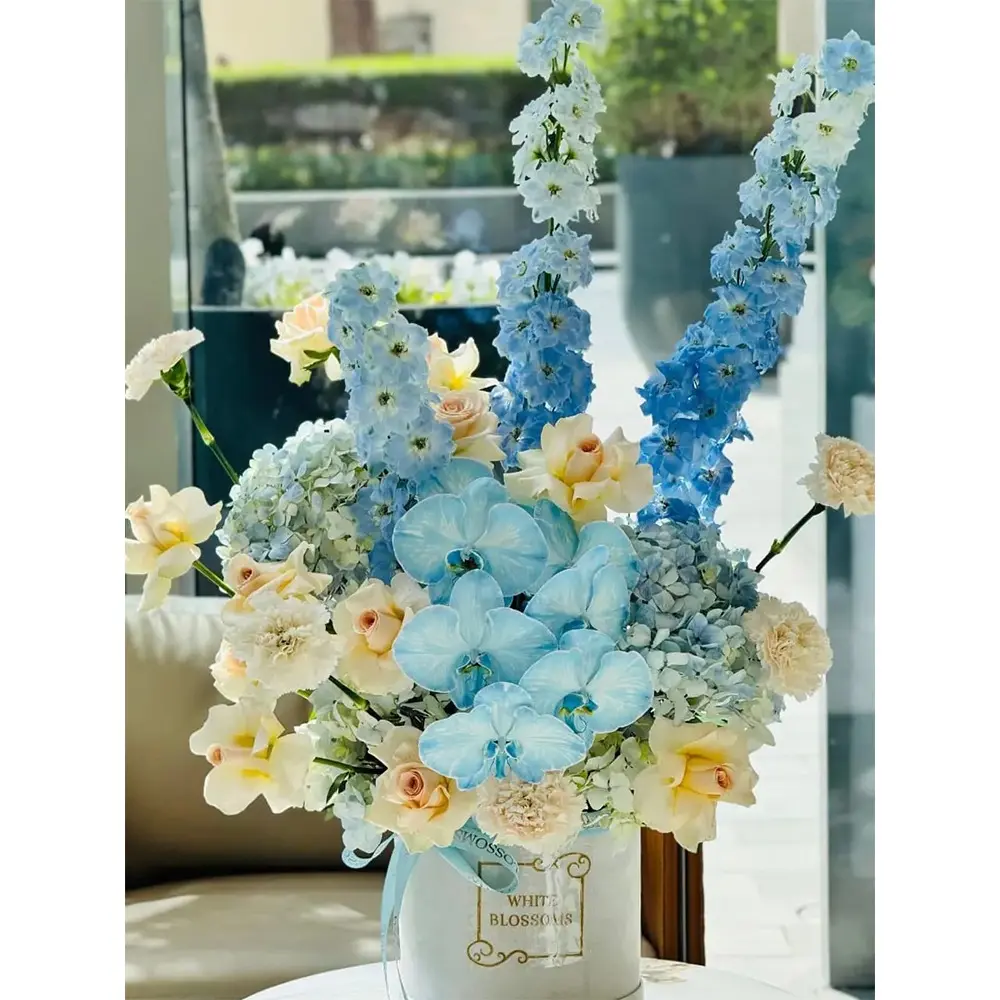 Frost orchid delphinium box by white blossoms