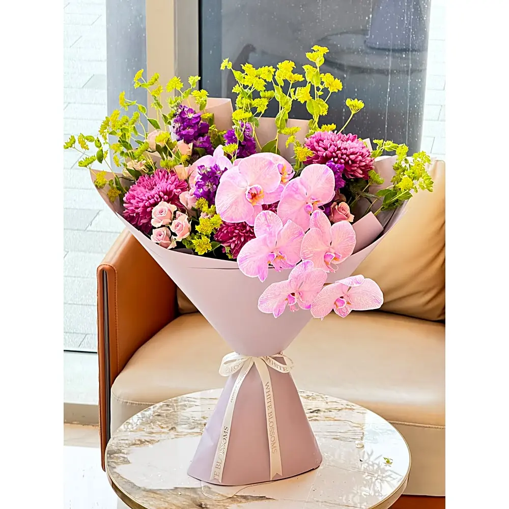 Wildberry Bloom Bouquet with pink orchids, magenta chrysanthemums, and purple stock flowers, White Blossoms flower boutique Dubai Abu Dhabi