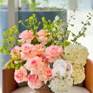 Countryside Rose Basket with coral-pink roses, white orchids, and hydrangeas in a woven basket, White Blossoms flower boutique Dubai Abu Dhabi