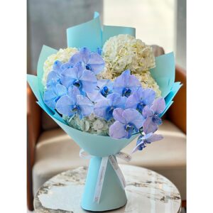 Violet-blue orchid bouquet with white hydrangeas in turquoise wrap, White Blossoms flower boutique Dubai Abu Dhabi