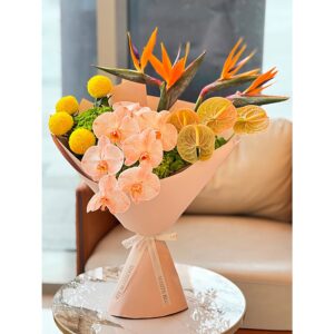 Tropical bouquet with bird of paradise, peach orchids, and yellow craspedia, White Blossoms flower boutique Dubai Abu Dhabi