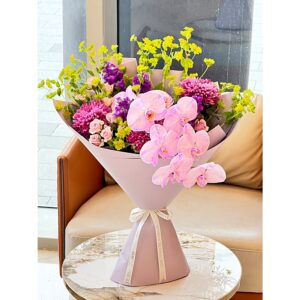 Wildberry Bloom Bouquet with pink orchids, magenta chrysanthemums, and purple stock flowers, White Blossoms flower boutique Dubai Abu Dhabi